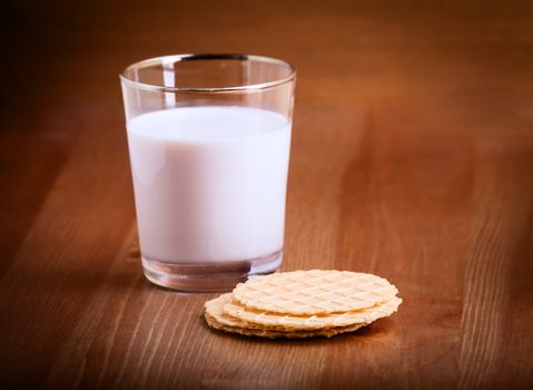 A glass of Milk and crackers served on the table