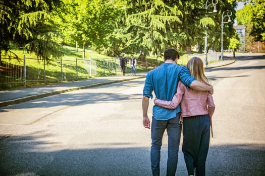 Attractive couple, young men and girl standing next to each other