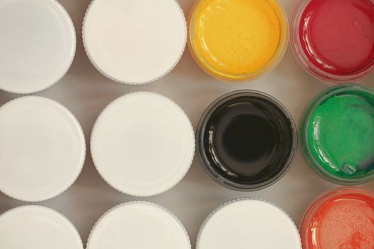 Colorful Gouache set of artistic cans Macro shot top view