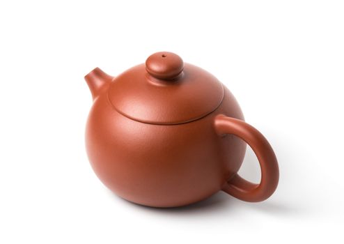 Small brown earthenware teapot with closed lid isolated on white background