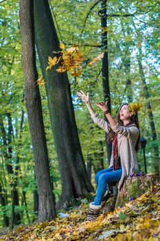 smiling, happy girl drop up the leaves