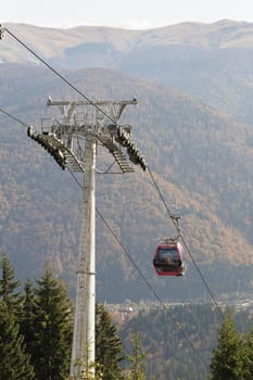 Cableway in Romanian Carpathians during summertime with passenger cabin moving