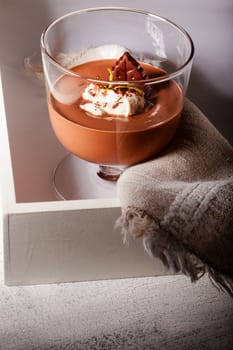 Glass with Chocolate Mousse Dessert served on a wooden surface