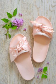 Rose pink woman slippers on wooden background
