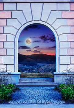 Frame of desolate immured door with picture of night mountain and steps of cut stone at night