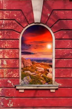 old window frame on the wall with picture of stones on sunset