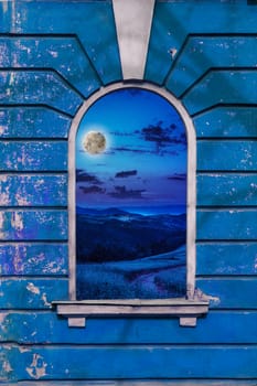 old window frame on the wall with picture of night moon landscape