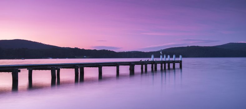 Port Arthur pier and hillside at dusk in Tasmania, Australia.