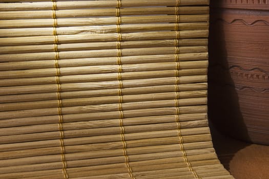 Napkin bamboo and earthen jar on a wooden background