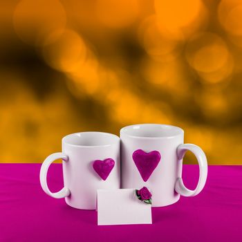 love card with blur background. purple heart on a white tea cup on a gold background