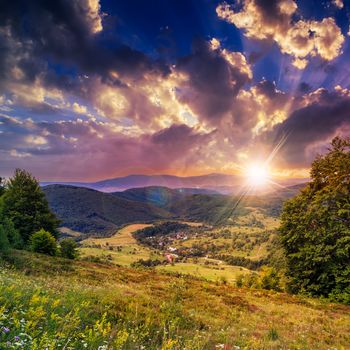 autumn landscape. village on the hillside. forest on the mountain light fall on clearing on mountains in evening