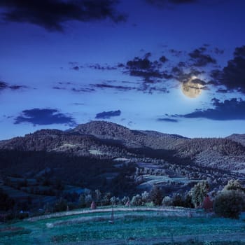 cold morning fog with red hot sunrise in the mountains in moon light