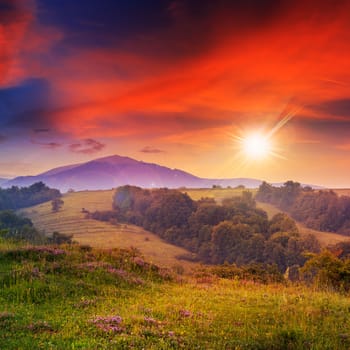 cold morning fog with red hot sunrise in the mountains in evening