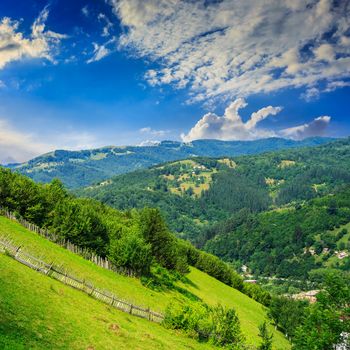 autumn landscape. village on the hillside. forest on the mountain light fall on clearing on mountains