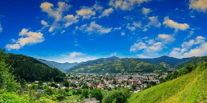 autumn landscape. village on the hillside. forest on the mountain light fall on clearing on mountains