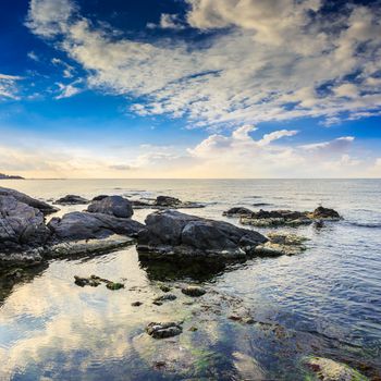 sea wave attacks the boulders and is broken about them