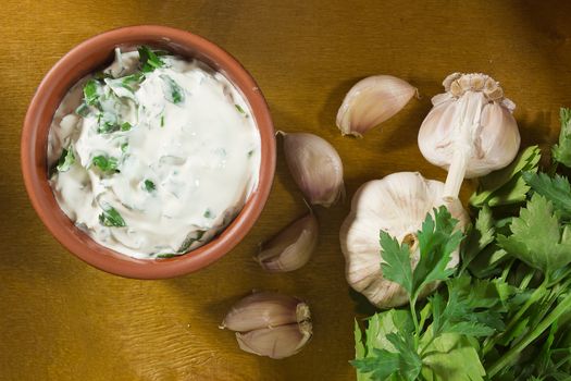 Garlic dip sauce with fresh green parsley leaves