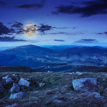 white sharp stones on the hillside at night in moon light