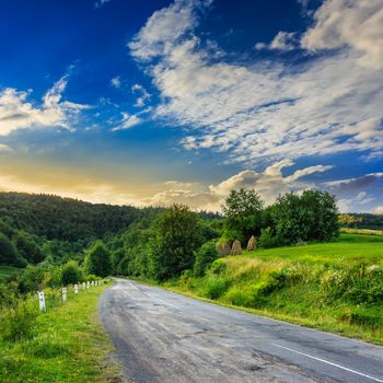 asphalt road going to mountain, passes rural places