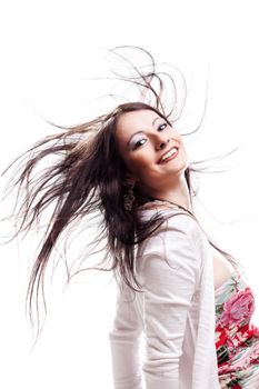 beautiful girl with hair in the air, smiling and looking at camera
