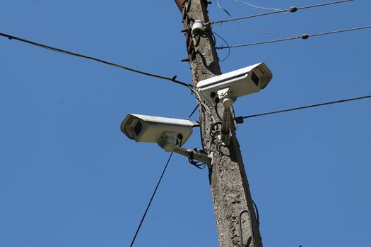 CCTV camera hanging over the entrance of a house.