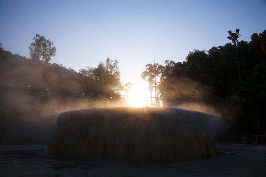 volcanic natural hot spring mineral water pool with steam spa and sun reflect light travel landmark background lampang thailand landscape colorful dark tone