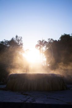 volcanic natural hot spring mineral water pool with steam spa and sun reflect light travel landmark background lampang thailand landscape colorful dark tone, Ruksavarin Hot Spring 
Ranong Thailand.