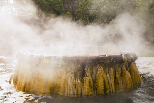 volcanic natural hot spring mineral water pool with steam spa and sun reflect light travel landmark background lampang thailand landscape colorful dark tone