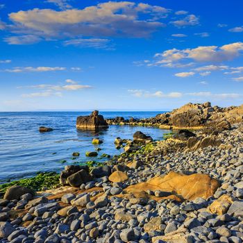 calm sea wave wash  boulders on rocky shore