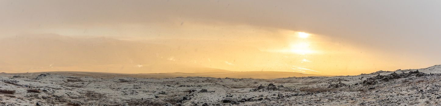 Snowy Winter Mountain range with sun light in Reykjavik Iceland panorama