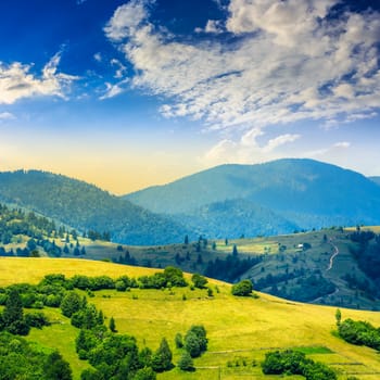 summer landscape. village on the hillside. forest on the mountain light fall on clearing on mountains