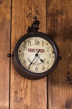 old and vintage clock on a wooden wall