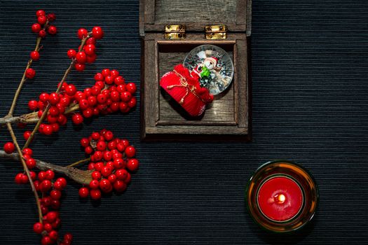 candle,ashberry and box on the black backgraund