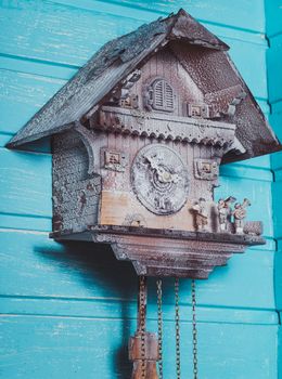 Vintage cuckoo clock on the wooden backgraund