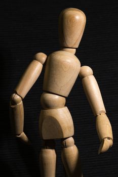 Wooden man on a black background