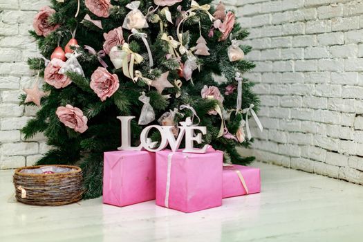 Beautiful holdiay decorated room with Christmas tree with presents under it