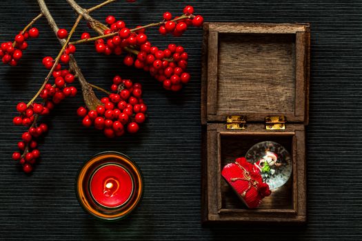 candle,ashberry and box on the black backgraund