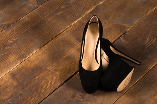 A pair of woman's shoes on a wooden floor
