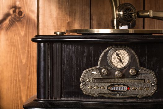 old and vintage gramophone on a wooden background