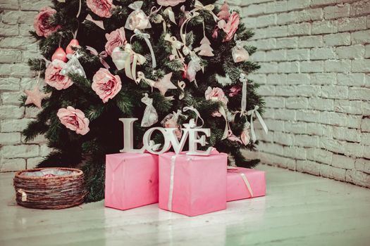 Beautiful holdiay decorated room with Christmas tree with presents under it