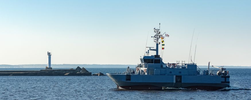 Small grey military ship moving from Baltic sea