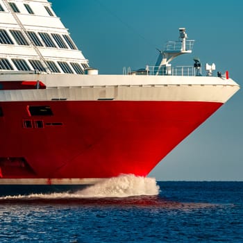 Red cruise liner. Large passenger ferry underway