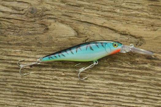 striped wobbler for fishing on wooden background