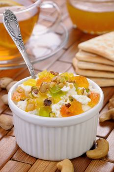 portion of cottage cheese with jam and marmalade slices, nuts, pistachios