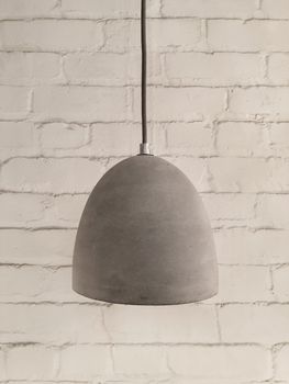 Concrete lamp on white brick background. Modern design.