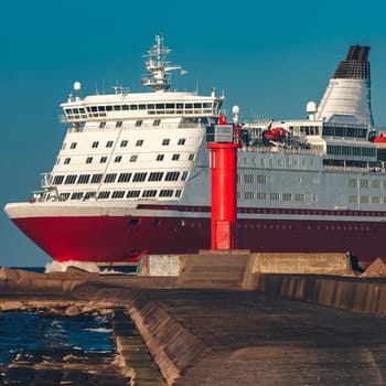 Red cruise liner. Large passenger ferry underway