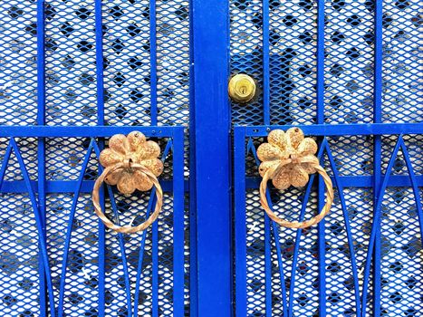 Blue iron gate with ornamental details. Montreal, Quebec, Canada.