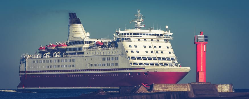 Red cruise liner. Large passenger ferry underway
