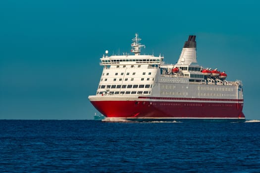 Red cruise liner. Large passenger ferry underway