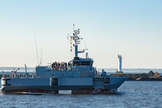 Small grey military ship moving from Baltic sea